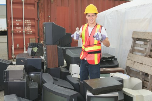 Professional waste removal team handling large waste containers